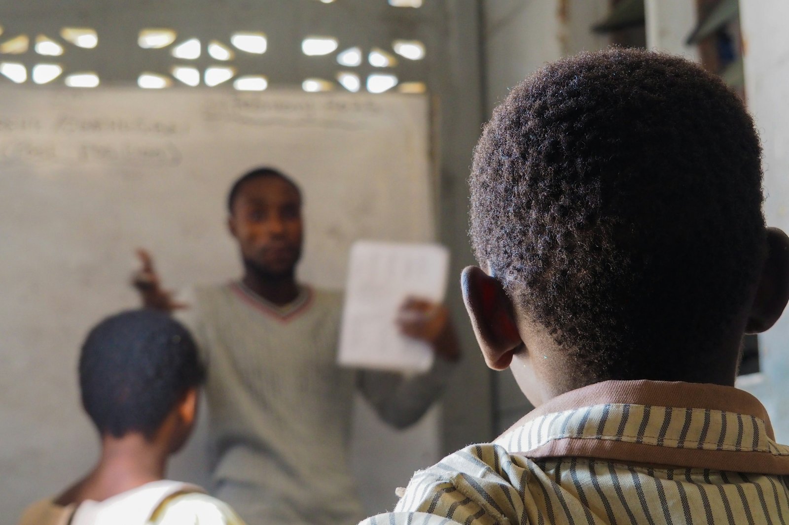 A teacher engaging with students in a classroom